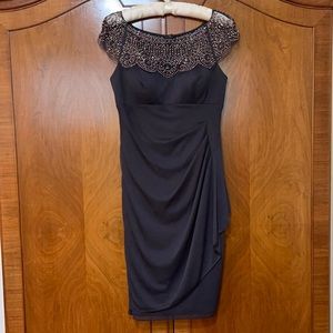 Escape Dark gray dress with beaded neckline.